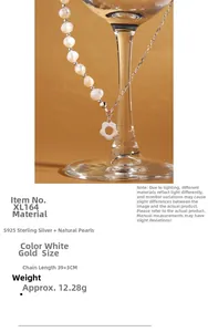Detail of S925 sterling silver necklace with flower pendant and natural pearl on glass