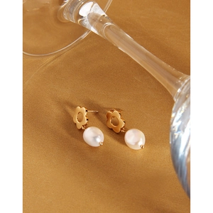 Detailed macro view of S925 silver needle flower earrings with elegant oval pearl pendants