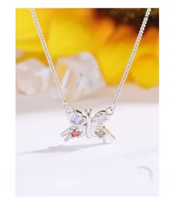 Detailed close-up of a silver butterfly necklace with colorful gemstone butterfly wings