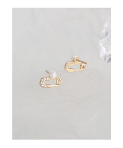 Detail of gold safety pin earrings with S925 stamp, pearl and micro diamonds
