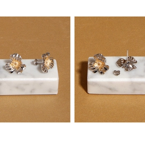 Macro detail of S925 sterling silver floral earrings with golden stamen and hallmark