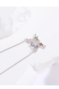 Macro view of S925 silver butterfly pendant with colorful gemstones and fine metal chain