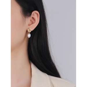Elegant gold flower stud earrings with white oval pearl drops for women