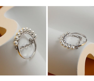 Detailed macro view of S925 sterling silver ring with eight white pearls and chain element