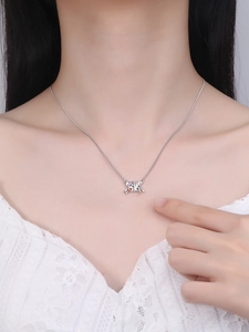 Close-up of butterfly pendant necklace with colorful zircons on a model's neck