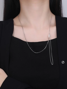 Detail view of S925 sterling silver chain necklace featuring white pearls and tassels