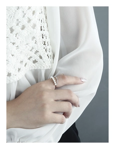 Detail view of a double-layer S925 silver ring featuring pearls and a textured chain link