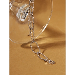 Detail of S925 sterling silver chain with round beads, oval rings, and lobster clasp