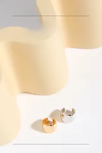 Polished S925 sterling silver ear cuffs in gold and silver finish on display