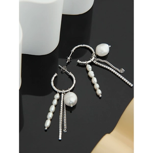 Detailed close-up of S925 silver earrings with freshwater pearls and zircon tassels