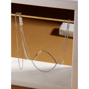 Detailed close-up of layered S925 sterling silver chain necklace with elegant white pearls