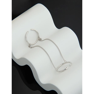Detail of S925 sterling silver double ring with delicate chain connector on wave pedestal