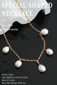 Close-up of golden necklace featuring five natural white baroque pearls on a fine link chain