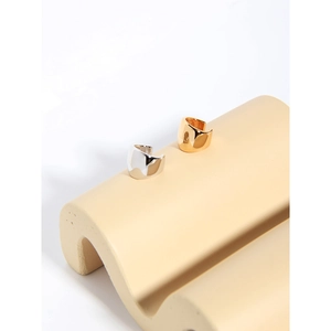 Minimalist wide band ear cuffs in polished gold and silver on curved display