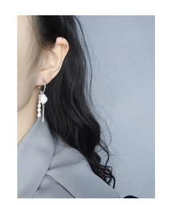 Elegant silver tassel earrings with baroque pearl and micro-bead chain on model