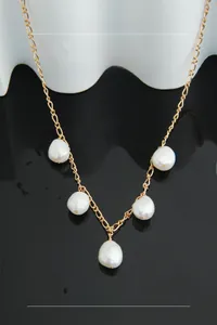 Detail of five baroque pearls on a gold minimalist S925 sterling silver chain necklace