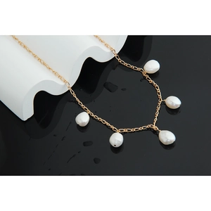 Detail of five baroque pearls on a gold S925 sterling silver chain with water droplets