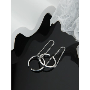 Close-up of minimalist S925 sterling silver ear cuffs with long chain detail on white waves