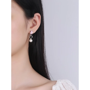 Pink zircon and heart pearl drop earrings in S925 sterling silver worn by a model