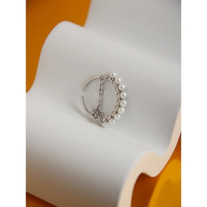 Detailed macro view of S925 silver ring featuring pearls and an inner chain link detail