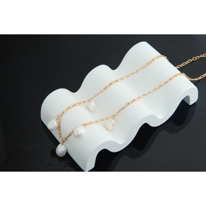 Detail of five baroque pearls on a gold S925 sterling silver chain for women