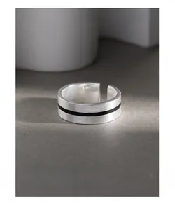 Macro shot of S925 sterling silver ring featuring brushed metal and black enamel detail