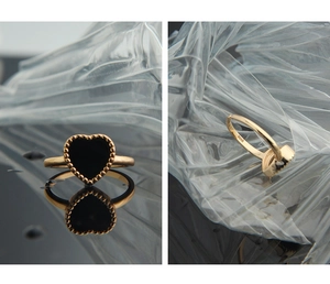 Detail of S925 sterling silver ring featuring a black heart enamel with gold beaded edges