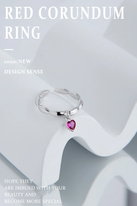 Detail of S925 silver heart ring with red corundum on minimalist white display