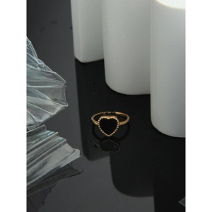 Detail of adjustable golden heart ring with black inlay and beaded caviar texture edge