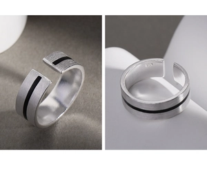 Detailed macro view of S925 sterling silver ring with brushed finish and black enamel line
