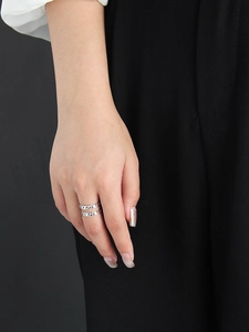 Detail of silver S925 sterling silver U-shaped double chain ring worn by a model