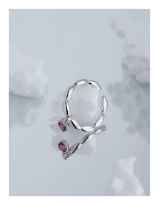 Detailed view of silver heart ring with pink zircon gemstone and segmented band