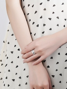 Close-up of a S925 sterling silver ring featuring a brushed texture and black enamel inlay