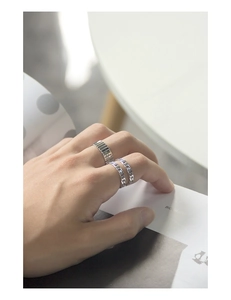 Detailed shot of S925 sterling silver U-shaped double chain ring on hand against white background