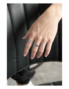 Detailed view of silver stackable rings set with U-shaped chains and vertical grooves