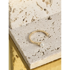 Minimalist S925 sterling silver open ring with round white pearl and zircon on stone surface