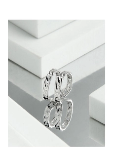 Detail view of S925 sterling silver Cuban link ring on a reflective white geometric base