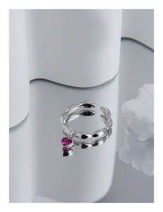 Macro view of S925 sterling silver ring featuring a pink heart-shaped crystal pendant