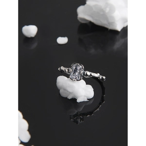 Minimalist S925 sterling silver ring with rectangular gemstone on black reflective base