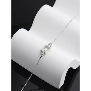Elegant S925 sterling silver horseshoe bracelet with sparkling zircon on a white stand