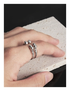 Close-up of S925 sterling silver ring featuring liquid metal design and round beads