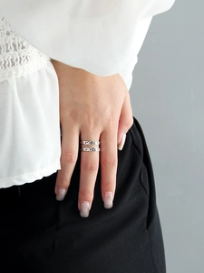Detail of S925 sterling silver U-shaped double chain ring worn on a finger