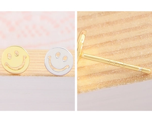Detail of S925 sterling silver stamp on minimalist gold and silver smiley face studs