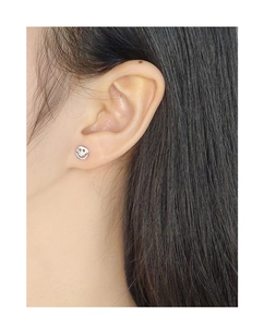 Close-up of model wearing minimalist silver round smiley face stud earrings in S925 silver