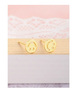 Detailed view of gold plated round smiling face stud earrings on a warm wooden stand