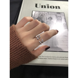 Detail of irregular S925 sterling silver ring with organic lava melt design and metallic finish
