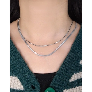 Double-layered silver snake chain necklace featuring a minimalist flat weave design