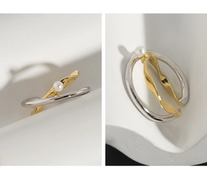 Dettaglio del marchio S925 sull'anello bicolore intrecciato con perla stile minimal