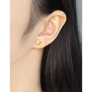 Minimalist S925 silver smiley face stud earrings with gold finish on female model