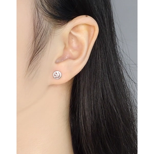 Minimalist S925 sterling silver smiley face stud earrings worn on a female model